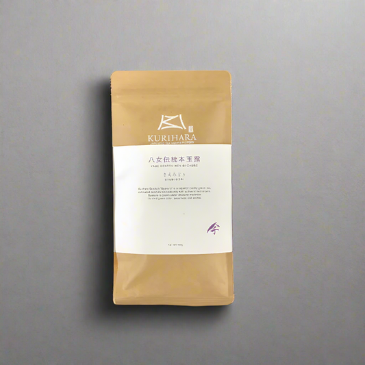 Kurihara coffee package on a wooden surface with a gray background