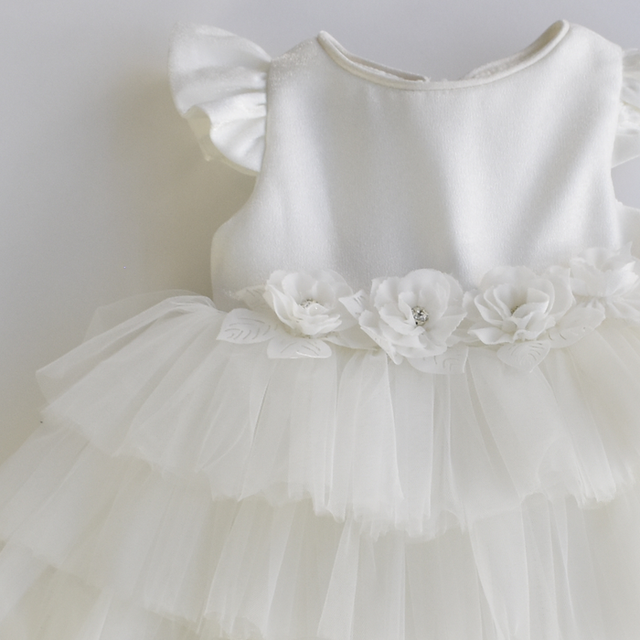 Elegant white baby dress with flutter sleeves, a layered tulle skirt, and a satin bodice adorned with delicate 3D floral appliqués at the waistline.