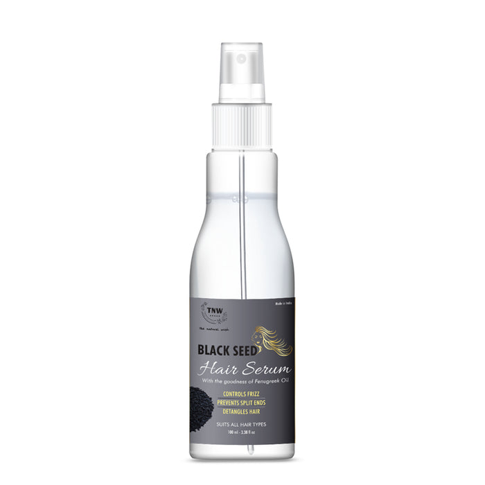 A clear spray bottle labeled 'Black Seed Hair Serum', indicating that it's a hair care product