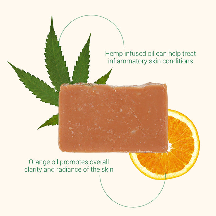 Bar of soap with a hemp leaf and orange slice on a white background
