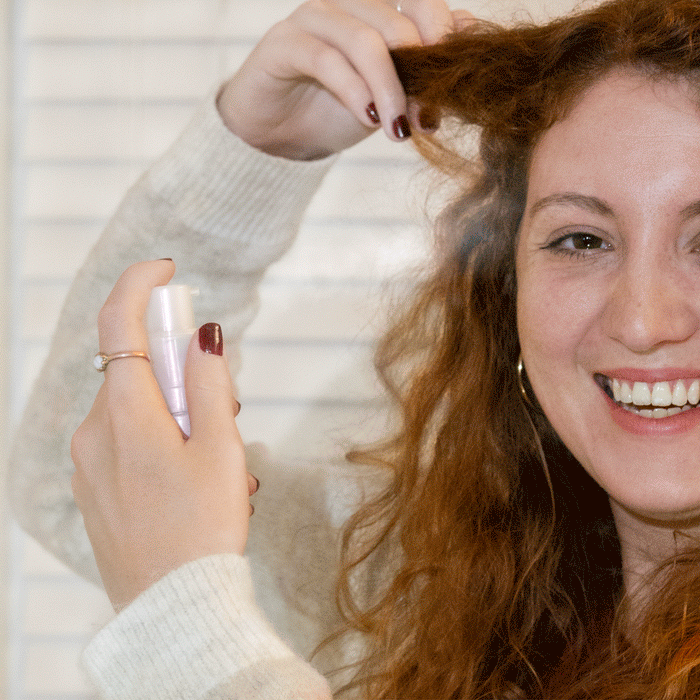 animated photo of aerosol-free pump bottle of Manic Panic Hair Freshener spraying into a woman hair