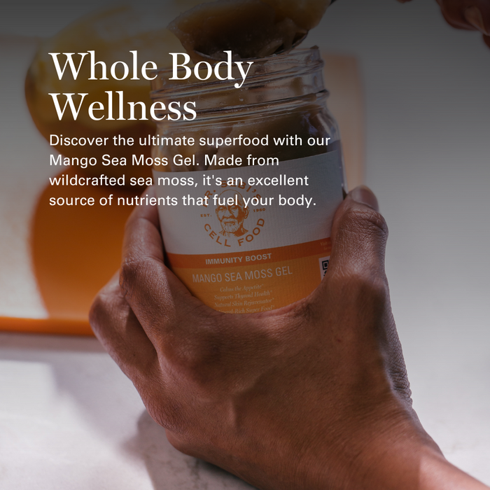 Hand holding Dr. Sebi's Mango Sea Moss Gel jar with orange immunity boost label against white background.