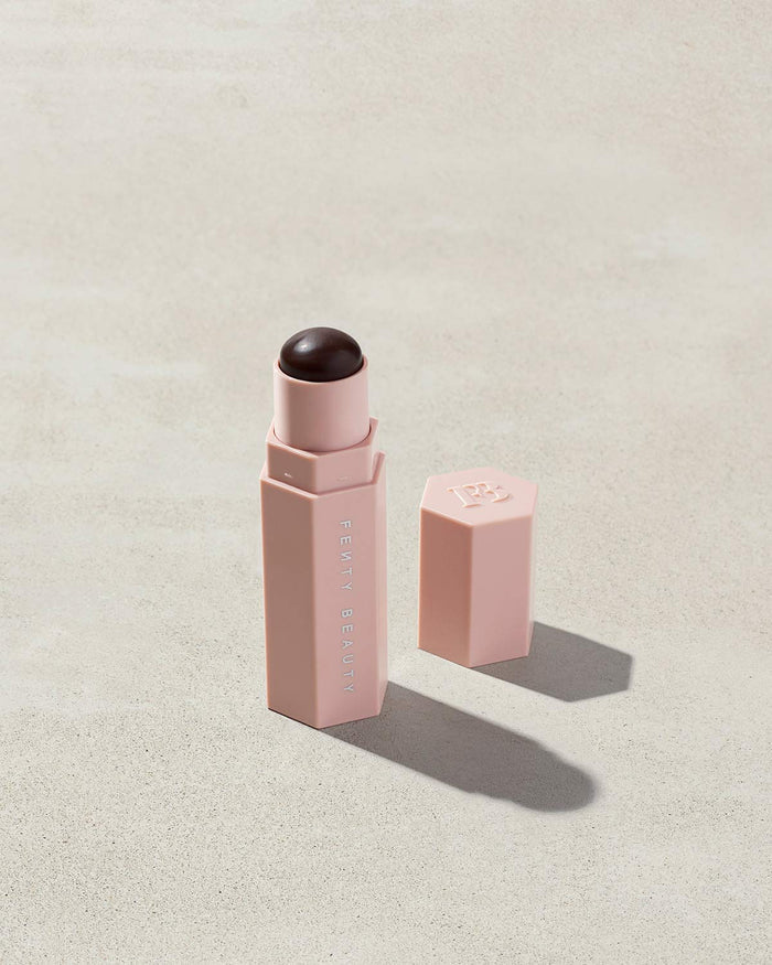 Opened Match Stix Contour Skinstick in the shade Caviar container on a grey background.