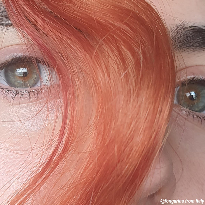 Close up of hair  swooped between someone's eyes showing the beauty Manic Panic's Tiger's Eye