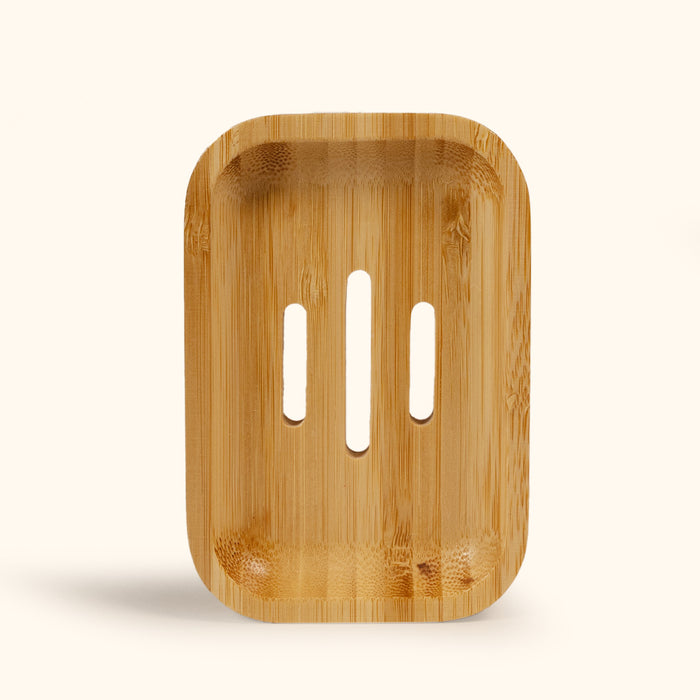 Top view of a bamboo soap dish with three drainage slots, designed to keep bar soap dry between uses.